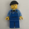 Man, Blue Overalls over Shirt, Blue Legs, Black Hat, Reddish Brown Eyebrows