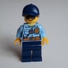 Policewoman Sam Solo, Bright Light Blue Shirt with Radio and Badge, Dark Blue Legs, Dark Blue Cap with Hair, Sunglasses
