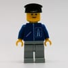 Man, Blue Jacket with Highway Logo, Light Gray Legs, Black Hat